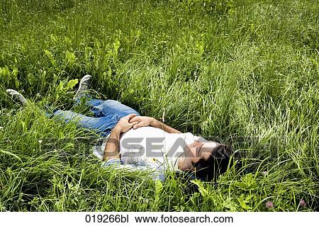 full body portrait of young man dozing in grass View Large Photo Image Stock Image - full body portrait of young man dozing in grass. Fotosearch