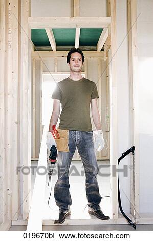 full body portrait of young man standing in door of house under construction View Large Photo Image Stock Image - full body portrait of young man standing in door of house under construction. Fotosearch