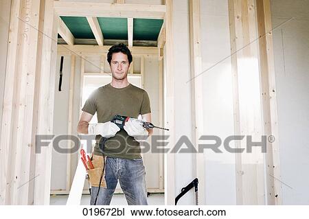 full body portrait of young man standing in door of house under construction View Large Photo Image Stock Image - full body portrait of young man standing in door of house under construction. Fotosearch