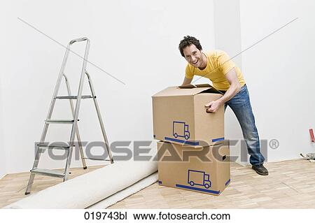 full body portrait of young man with moving boxes in his new home View Large Photo Image Stock Image - full body portrait of young man with moving boxes in his new home. Fotosearch