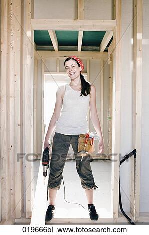full body portrait of young woman standing in door of house under construction View Large Photo Image Stock Image - full body portrait of young woman standing in door of house under construction. Fotosearch