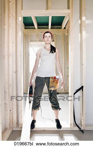 full body portrait of young woman standing in door of house under construction View Large Photo Image Stock Image - full body portrait of young woman standing in door of house under construction. Fotosearch