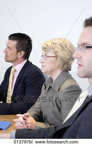 Stock Image - group of business people at meeting table. Fotosearch