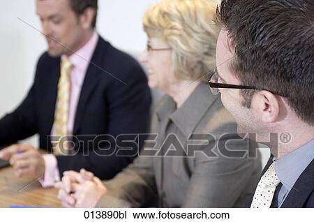group of business people smiling during meeting View Large Photo Image Stock Image - group of business people smiling during meeting. Fotosearch