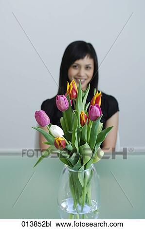 happy female executive behind tulips in vase View Large Photo Image Stock Image - happy female executive behind tulips in vase. Fotosearch