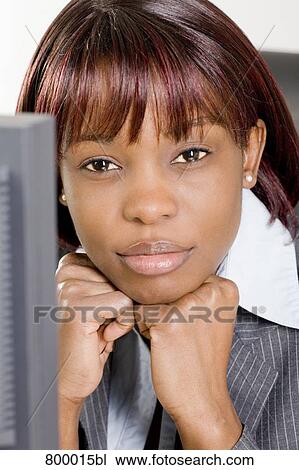 headshot of black businesswoman sitting behind computer View Large Photo Image Stock Image - headshot of black businesswoman sitting behind computer. Fotosearch