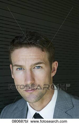 Stock Image - headshot of business wearing tie and suit. Fotosearch