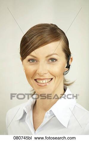 headshot of businesswoman wearing headset for mobile phone View Large Photo Image Stock Image - headshot of businesswoman wearing headset for mobile phone. Fotosearch