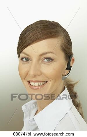 headshot of businesswoman wearing headset for mobile phone View Large Photo Image Stock Image - headshot of businesswoman wearing headset for mobile phone. Fotosearch