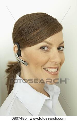 headshot of businesswoman wearing headset for mobile phone View Large Photo Image Stock Image - headshot of businesswoman wearing headset for mobile phone. Fotosearch