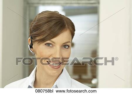 headshot of businesswoman wearing headset for mobile phone View Large Photo Image Stock Image - headshot of businesswoman wearing headset for mobile phone. Fotosearch