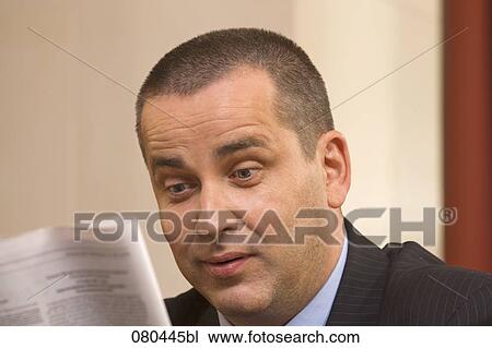 headshot of mature businessman sitting in hotel lobby reading newspaper View Large Photo Image Stock Image - headshot of mature businessman sitting in hotel lobby reading newspaper. Fotosearch
