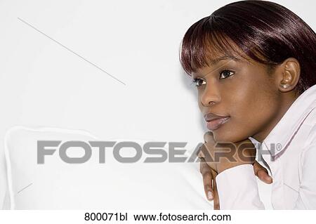 headshot of melancholic black woman sitting on sofa View Large Photo Image Stock Image - headshot of melancholic black woman sitting on sofa. Fotosearch