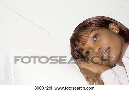 headshot of melancholic black woman sitting on sofa View Large Photo Image Stock Image - headshot of melancholic black woman sitting on sofa. Fotosearch