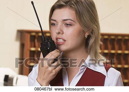 headshot of young female hotel employee using walkie-talkie View Large Photo Image Stock Image - headshot of young female hotel employee using walkie-talkie. Fotosearch