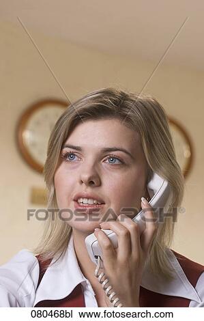 headshot of young hotel receptionist talking on telephone View Large Photo Image Stock Image - headshot of young hotel receptionist talking on telephone. Fotosearch