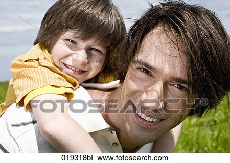 headshot of young man giving son a piggyback ride View Large Photo Image Stock Image - headshot of young man giving son a piggyback ride. Fotosearch