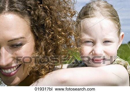 headshot of young woman giving daughter piggyback ride View Large Photo Image Stock Image - headshot of young woman giving daughter piggyback ride. Fotosearch