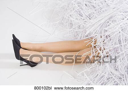 legs of young woman buried under shredded paper View Large Photo Image Stock Image - legs of young woman buried under shredded paper. Fotosearch