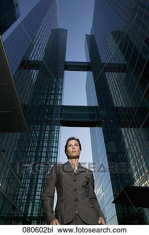 Stock Image - low angle portrait of mature businesswoman in front of office building. Fotosearch