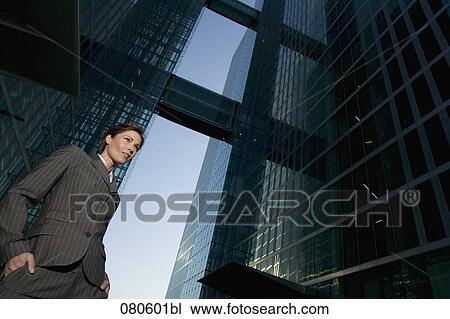 low angle view of mature businesswoman in front of office building View Large Photo Image Stock Image - low angle view of mature businesswoman in front of office building. Fotosearch