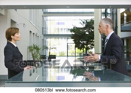 mature businessman talking to female employee at reception View Large Photo Image Stock Image - mature businessman talking to female employee at reception. Fotosearch