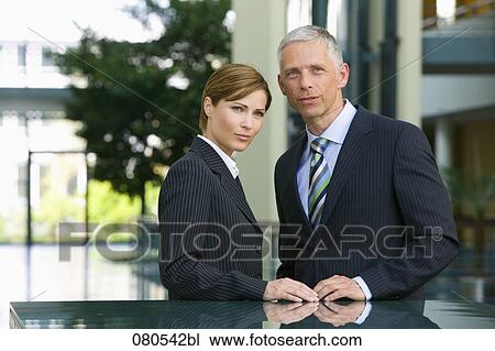 mature businesswoman and male colleague having conversation in office lobby View Large Photo Image Stock Image - mature businesswoman and male colleague having conversation in office lobby. Fotosearch
