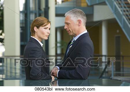 mature businesswoman and male colleague having conversation in office lobby View Large Photo Image Stock Image - mature businesswoman and male colleague having conversation in office lobby. Fotosearch