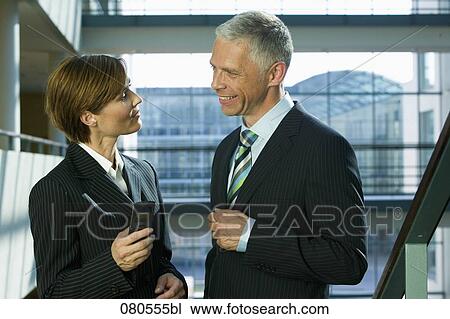 mature businesswoman and male colleague having a conversation View Large Photo Image Stock Image - mature businesswoman and male colleague having a conversation. Fotosearch