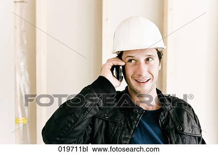 portrait of architect on construction site talking on mobile phone View Large Photo Image Stock Image - portrait of architect on construction site talking on mobile phone. Fotosearch