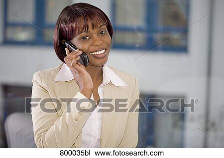 portrait of black businesswoman in front of window talking on mobile phone View Large Photo Image Stock Image - portrait of black businesswoman in front of window talking on mobile phone. Fotosearch
