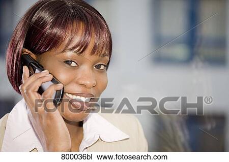 portrait of black businesswoman in front of window talking on mobile phone View Large Photo Image Stock Image - portrait of black businesswoman in front of window talking on mobile phone. Fotosearch