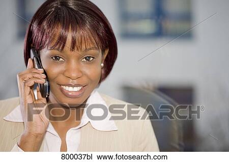 portrait of black businesswoman in front of window talking on mobile phone View Large Photo Image Stock Image - portrait of black businesswoman in front of window talking on mobile phone. Fotosearch