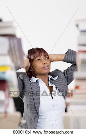 portrait of black businesswoman sitting behind piles of paper covering her ears View Large Photo Image Stock Image - portrait of black businesswoman sitting behind piles of paper covering her ears. Fotosearch