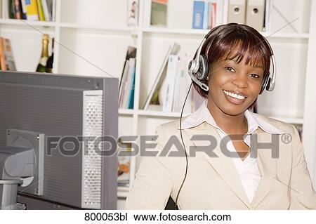 Stock Image - portrait of black businesswoman wearing headset. Fotosearch