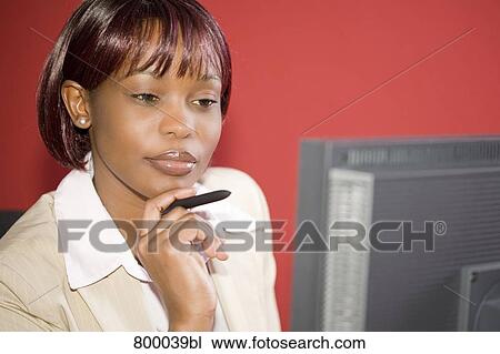 portrait of black executive looking at computer screen View Large Photo Image Stock Image - portrait of black executive looking at computer screen. Fotosearch