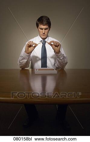 portrait of businessman at desk breaking pencil View Large Photo Image Stock Image - portrait of businessman at desk breaking pencil. Fotosearch