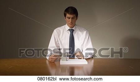 portrait of businessman at desk using pencil sharpener View Large Photo Image Stock Image - portrait of businessman at desk using pencil sharpener. Fotosearch