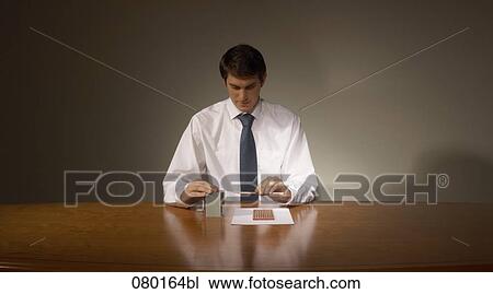 portrait of businessman at desk using pencil sharpener View Large Photo Image Stock Image - portrait of businessman at desk using pencil sharpener. Fotosearch