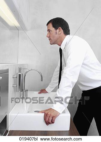 portrait of businessman checking his looks in mirror View Large Photo Image Stock Image - portrait of businessman checking his looks in mirror. Fotosearch