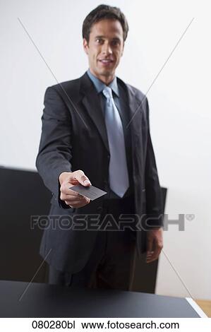 portrait of businessman handing out his business card View Large Photo Image Stock Image - portrait of businessman handing out his business card. Fotosearch