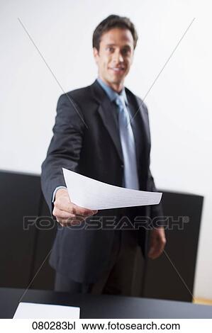portrait of businessman handing over document View Large Photo Image Stock Image - portrait of businessman handing over document. Fotosearch