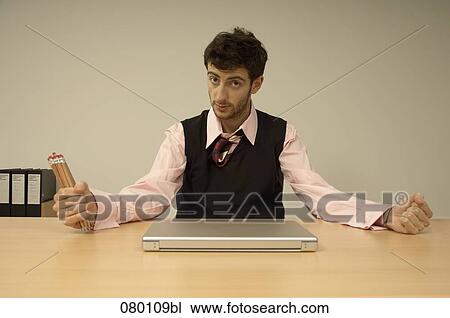 portrait of businessman holding pencils View Large Photo Image Stock Image - portrait of businessman holding pencils. Fotosearch
