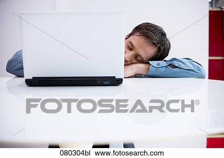portrait of businessman sleeping at desk with laptop computer in foreground View Large Photo Image Stock Image - portrait of businessman sleeping at desk with laptop computer in foreground. Fotosearch
