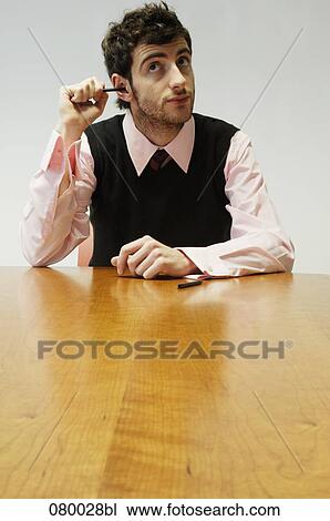 portrait of businessman sticking pencil into ear View Large Photo Image Stock Image - portrait of businessman sticking pencil into ear. Fotosearch