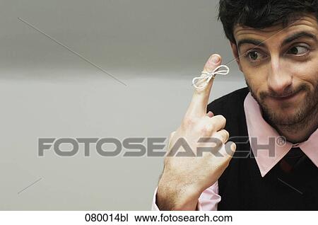 portrait of businessman with knot around index finger View Large Photo Image Stock Image - portrait of businessman with knot around index finger. Fotosearch