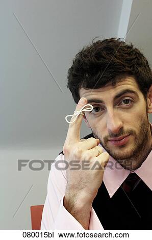 portrait of businessman with knot around index finger View Large Photo Image Stock Image - portrait of businessman with knot around index finger. Fotosearch