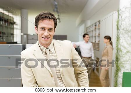 portrait of businessman with two colleagues having conversation in the background View Large Photo Image Stock Image - portrait of businessman with two colleagues having conversation in the background. Fotosearch