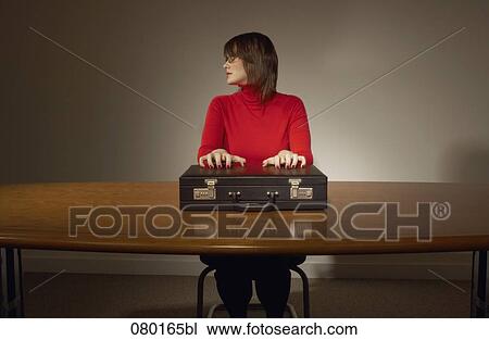 portrait of businesswoman sitting at desk with briefcase View Large Photo Image Stock Image - portrait of businesswoman sitting at desk with briefcase. Fotosearch