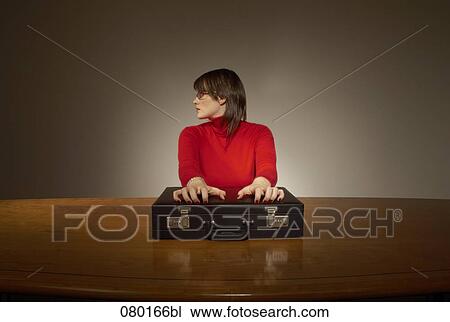 portrait of businesswoman sitting at desk with briefcase View Large Photo Image Stock Image - portrait of businesswoman sitting at desk with briefcase. Fotosearch